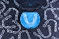 Plastic case with invisible transparent orthodontic retainers invisalign on black background. Aligner brackets or braces