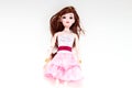 Plastic caucasian toy for girls. Brunette hair wearing doll