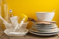 Plastic and Ceramic Stack dishes Recycle Concept Save Planet Yellow Background Royalty Free Stock Photo