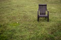 A plastic chair in a green grass field. Empty chair in a park Royalty Free Stock Photo