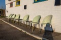 Plastic chairs against a wall. Cheap cafe outside dining area Royalty Free Stock Photo