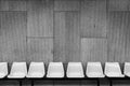 Plastic chairs on cement wall