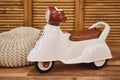 Plastic children motorcycle riding in the playroom, toy brown moped fo