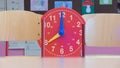 Plastic children`s analog clock in the classroom for interactive learning hours Royalty Free Stock Photo