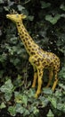 Plastic children`s toy of giraffe in a in green leaves Royalty Free Stock Photo