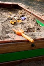 Plastic children toys in sandpit with sand at kids playground Royalty Free Stock Photo