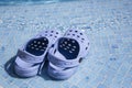 Plastic clogs near the swimming pool. Royalty Free Stock Photo