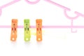 Plastic clothes pegs isolated on white background. Royalty Free Stock Photo