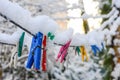 Plastic clothespins on a clothesline in winter after a snowfall Royalty Free Stock Photo
