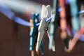 Plastic clothespins in a row on a washing line, close up with co Royalty Free Stock Photo