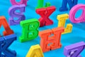 Plastic colorful alphabet letters close up on a blue