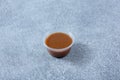 plastic condiment cup of balsamic vinaigrette dressing, brown, Royalty Free Stock Photo