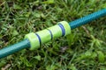 the plastic connector for the watering hose lies on the green grass Royalty Free Stock Photo