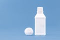 Plastic container, bottle of antiseptic hydrogen peroxide with cotton, medicine with blue background without label Royalty Free Stock Photo