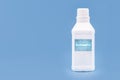 Plastic container, bottle written in English: antiseptic, solid blue background with copy space Royalty Free Stock Photo