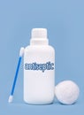 Plastic container, bottle written in English: antiseptic, solid blue background with copy space Royalty Free Stock Photo