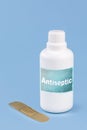 Plastic container, bottle written in English: antiseptic, solid blue background with copy space Royalty Free Stock Photo