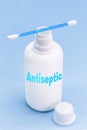Plastic container, bottle written in English: antiseptic, solid blue background with copy space Royalty Free Stock Photo