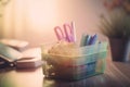 a plastic container filled with pens and pencils on a table Royalty Free Stock Photo