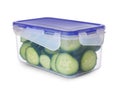 Plastic container with fresh cut cucumbers isolated on white Royalty Free Stock Photo