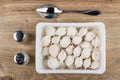 Plastic container with frozen dumplings, salt, pepper and spoon Royalty Free Stock Photo