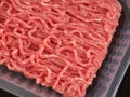 A plastic container with minced pork and beef in them lying on a black mat Royalty Free Stock Photo
