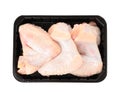 Plastic container with raw chicken wings on white, top view. Fresh meat Royalty Free Stock Photo