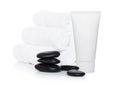 Plastic container of skin cream with spa towels Royalty Free Stock Photo