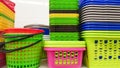 Plastic containers of different colors and prices are placed in a warehouse or store on display racks. Recycled plastic for sale,