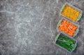 Plastic containers with frozen vegetables on table Royalty Free Stock Photo