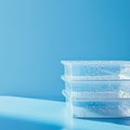 Plastic containers filled with water droplets stacked on top of each other Royalty Free Stock Photo