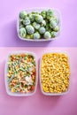 Plastic containers with frozen vegetables on color background, top view, Different frozen vegetables on table, corn brussels Royalty Free Stock Photo