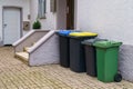 Plastic containers for garbage near the entrance to a residential building Royalty Free Stock Photo