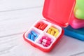 Plastic containers with pills on white wooden table Royalty Free Stock Photo