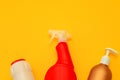 Plastic containers on a yellow background for the cleaning the kitchen, bathroom. Detergents, cleaning bottles, various