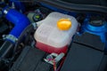 Plastic cooling liquid tank in car engine.