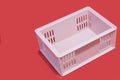 plastic crate containing light pink items, empty, placed on a red background, waiting to be used Royalty Free Stock Photo