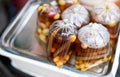 A plastic cup and plastic bag of cold assorted beans, lotus roots, ginkgo, longan and sweet syrup in street food shop in asian for