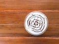 A plastic cup of coffee on blurred wooden table Royalty Free Stock Photo