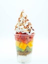 Plastic cup with cut fruit, ice cream, cream and syrup Royalty Free Stock Photo