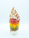 Plastic cup with cut fruit, ice cream, cream and syrup Royalty Free Stock Photo