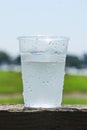 Plastic cup half full of water to show the ice melted outdoor