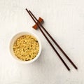 Plastic cup of instant ramen noodles, overhead square shot with chopsticks Royalty Free Stock Photo