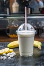 Plastic cup of milkshake with banana Royalty Free Stock Photo