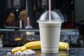 Plastic cup of milkshake with banana Royalty Free Stock Photo