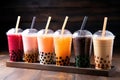 Plastic cups of different tasty bubble tea. Row of fresh boba bubble tea glasses. Generative AI Royalty Free Stock Photo