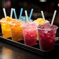 Plastic cups hold frozen fruit slushies, aligned in a colorful, frosty row Royalty Free Stock Photo