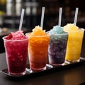 Plastic cups hold frozen fruit slushies, aligned in a colorful, frosty row Royalty Free Stock Photo