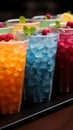 Plastic cups hold frozen fruit slushies, aligned in a colorful, frosty row