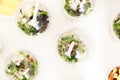 Plastic cups of microgreen salad on on white table background - top view Royalty Free Stock Photo